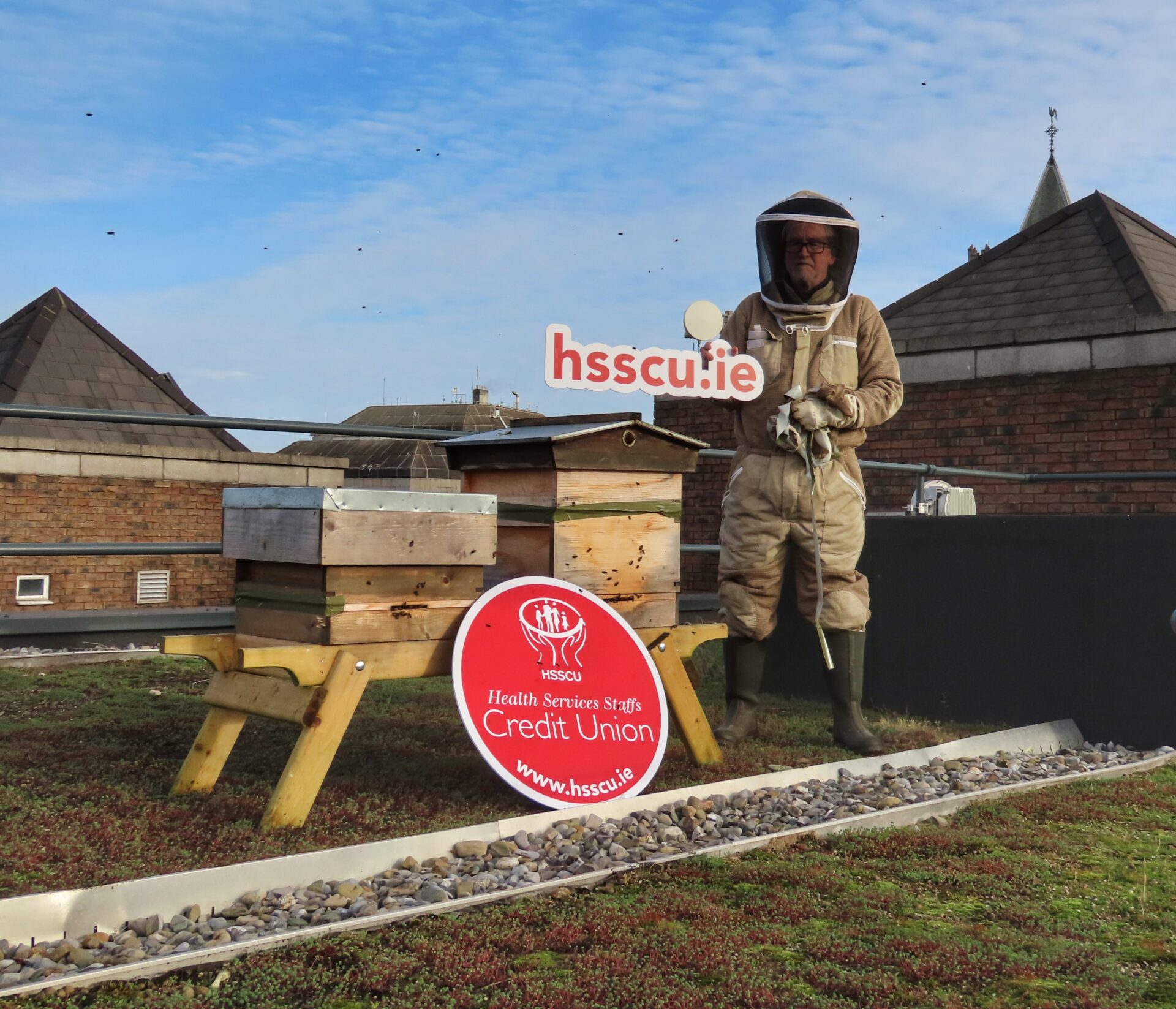 Beekeeper and beehives on HSSCU HIgh Street roof. 
